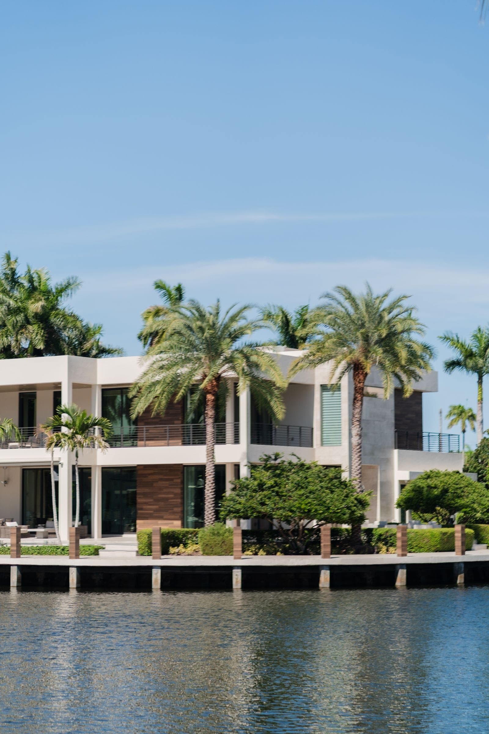 A waterfront villa with palm trees, the kind of home HoztSync is built to run